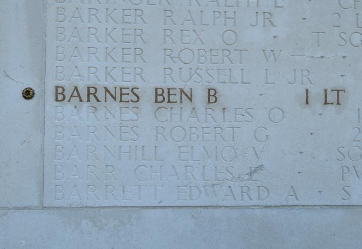 The name and rank of 1st Lt. Ben B. Barnes is highlighted on a stone wall. 