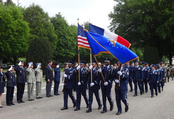 A color guard leads a group of marching Airmen into the ceremony.