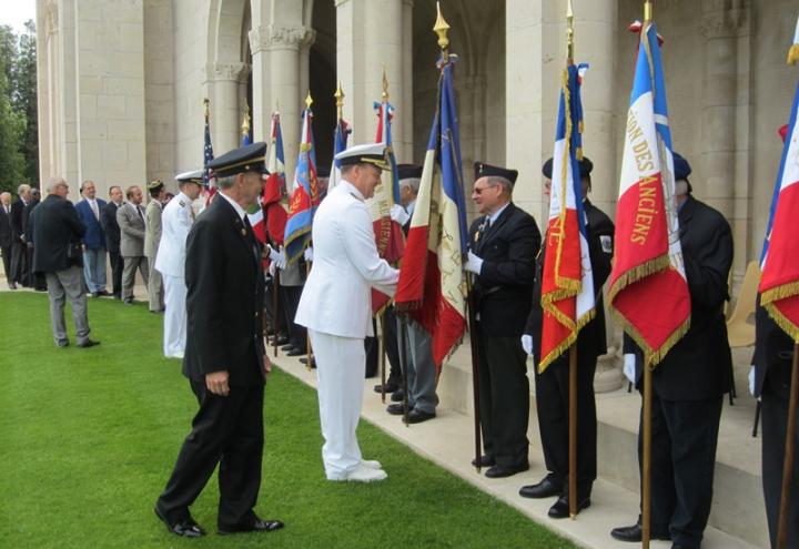 Rear Admiral Christenson shakes hands with flag bearers.