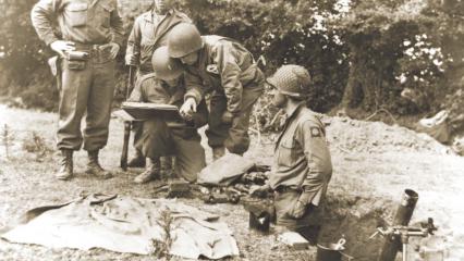 Colonel confers with an 81mm mortar crew, June 8, 1944.