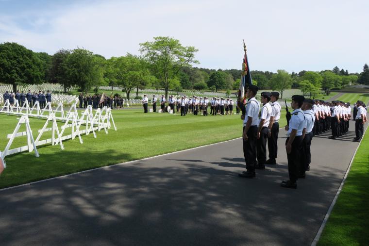 French and American military stand in formations during the ceremony. 