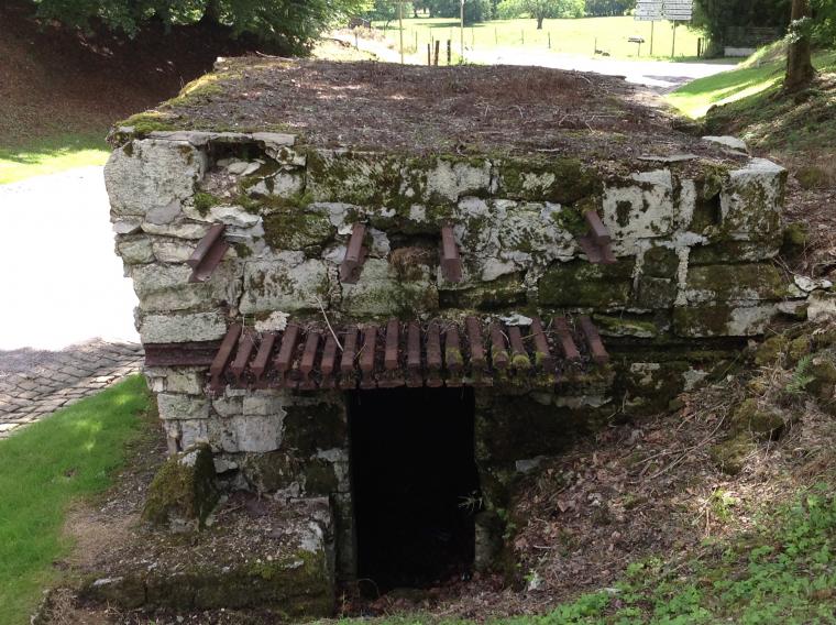 Modern day image showing a German bunker built into the hillside.