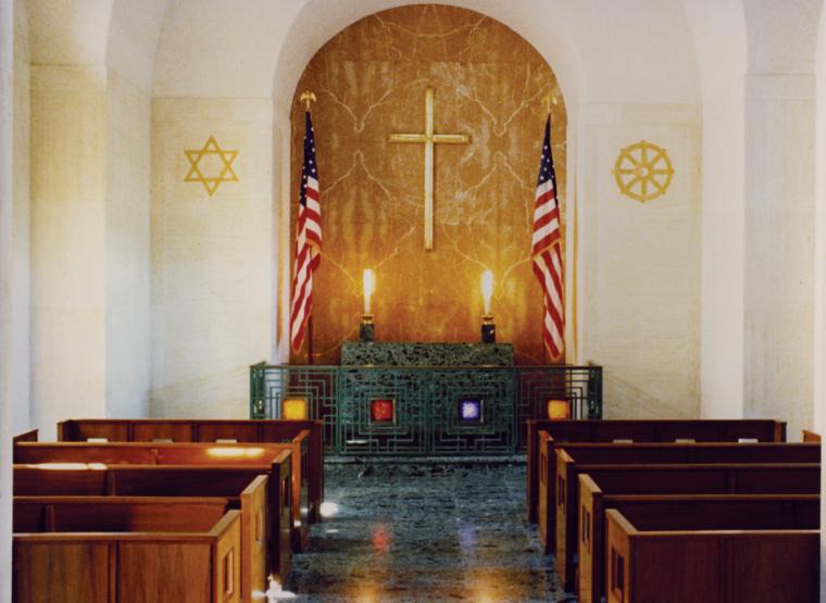 An altar flanked by two flags fills the inside of the chapel at the Honolulu Memorial. 