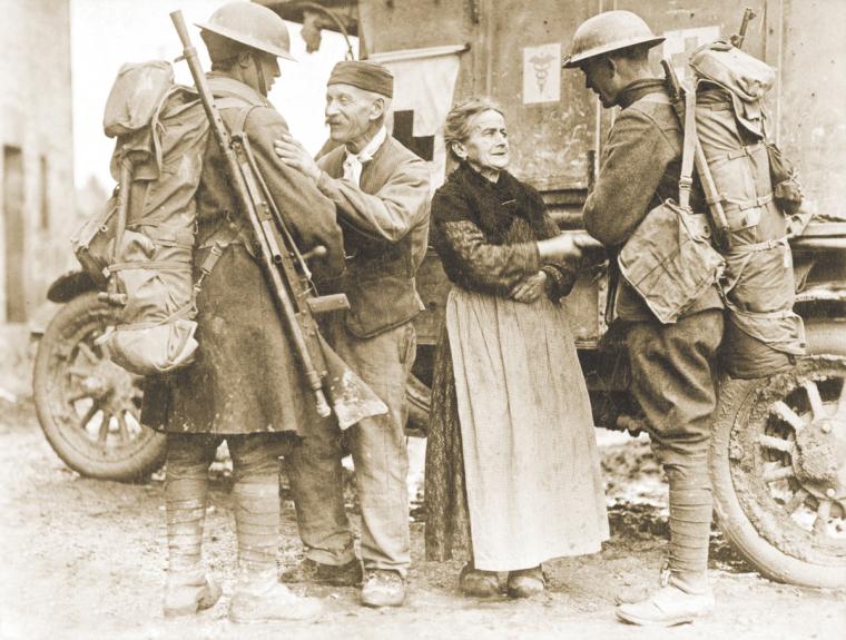 A French couple thanks U.S. soldiers who liberated their town on November 6, 1918.