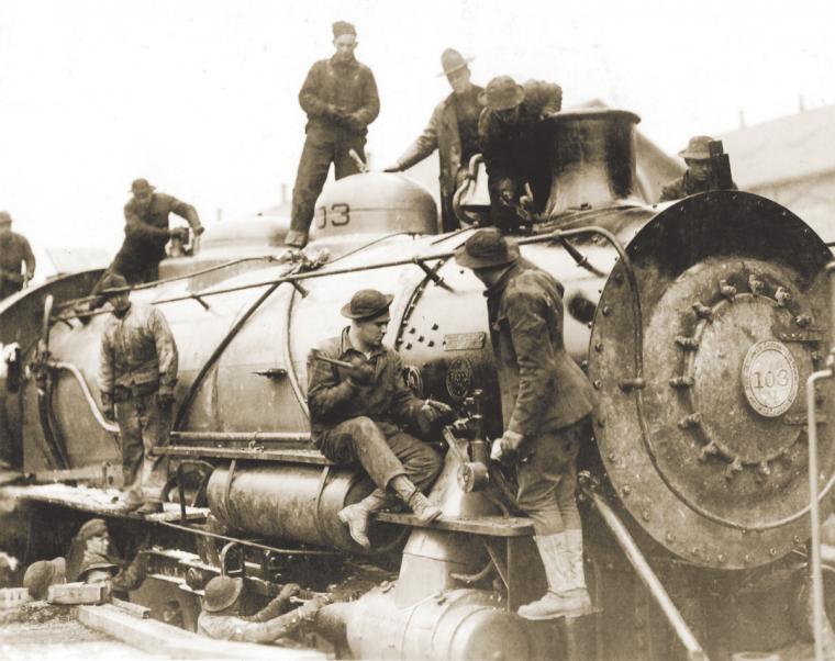 Services of Supply (SOS) soldiers build a locomotive at the assembly plant in St. Nazaire.