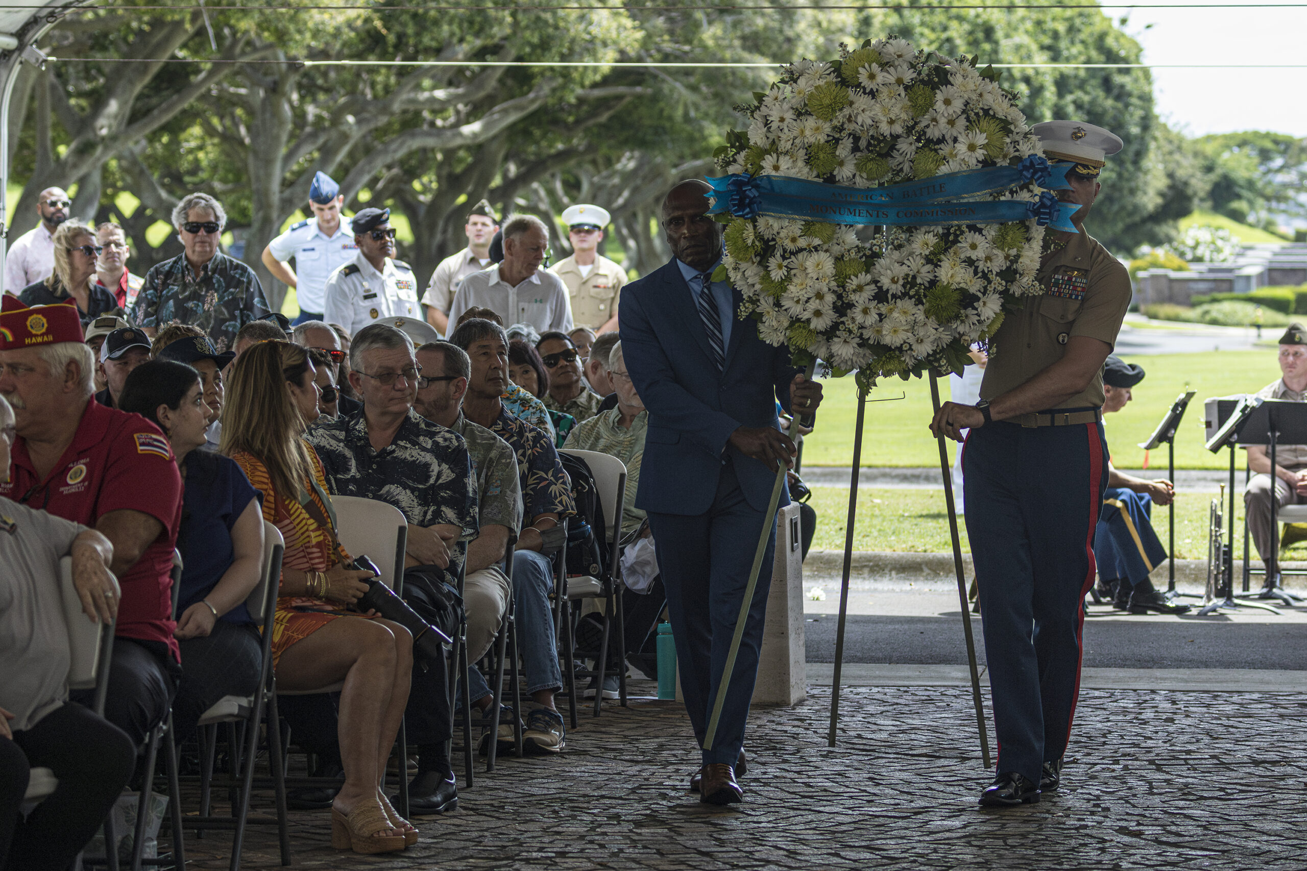 Picture of Commissioner John L. Estrada carrying the ABMC wreath. Credits: American Battle Monuments Commission. Picture of Commissioner John L. Estrada carrying the ABMC wreath. Credits: American Battle Monuments Commission.
