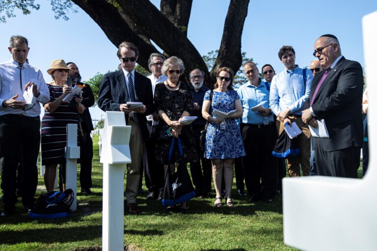 Family members paying their respects during the change of headstones at Manila American Cemetery