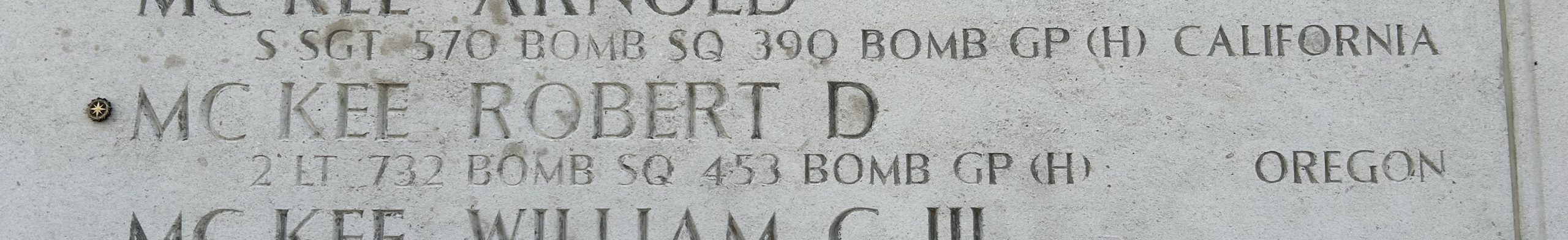 A bronze rosette next to the name of Robert D. McKee on the Wall of the Missing signifies he has been identified.