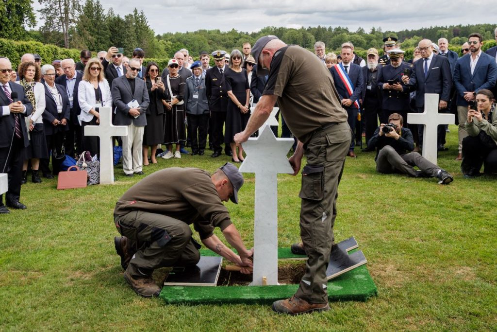 Members of the ABMC staff place the Star of David headstone at the grave of Pvt. Samuel Tamkin June 2, 2026, at Meuse-Argonne American Cemetery. (ABMC photo/NGuyen-Kim)