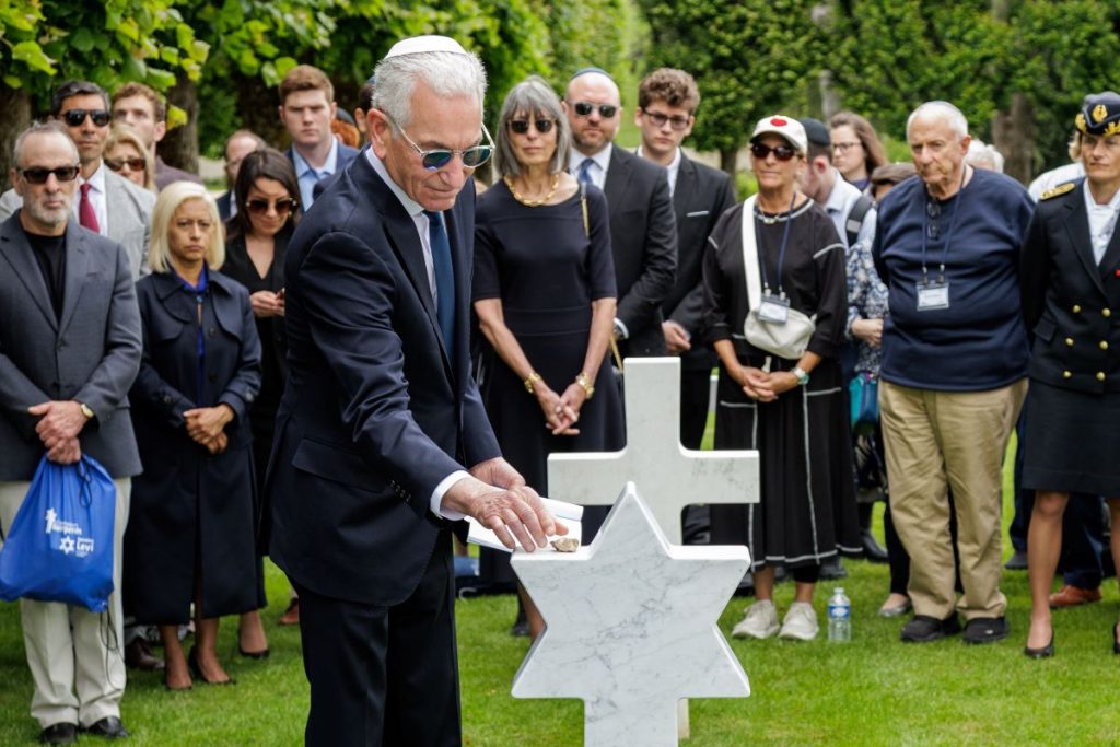 U.S. Ambassador to France Charles Kushner places a stone on the headstone of Pfc. Barney Bardman June 2, 2026, at Meuse-Argonne American Cemetery. (ABMC photo/NGuyen-Kim)