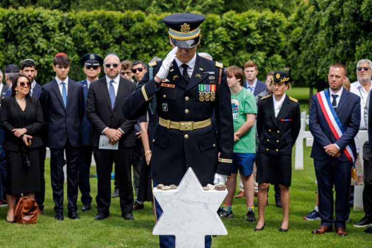U.S. Army Capt. Mikhael Smits renders a slow salute at the grave of Pfc. Maurice Akabas June 2, 2026, after Akabas' headstone was changed from a Latin cross to a Star of David at Meuse-Argonne American Cemetery. (ABMC photo/NGuyen-Kim)