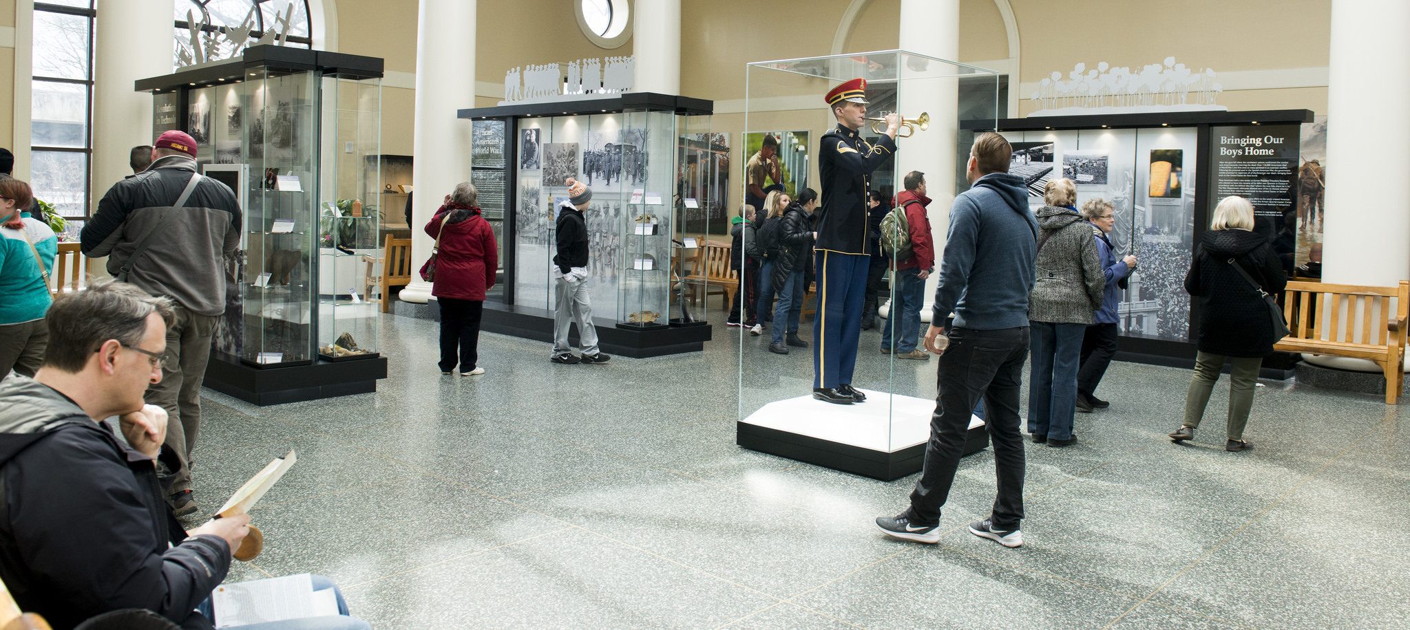 Visitors to Arlington National Cemetery view the new World War I exhibit in the Welcome Center