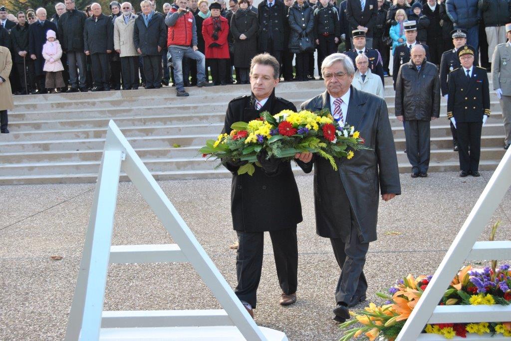 Participants in the 2013 Veterans Day Ceremony at Epinal American Cemetery lay a wreath.