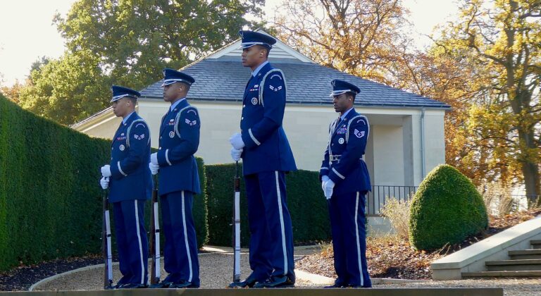 Airmen stand with firearms during the 2018 Veterans Day Ceremony at Cambridge American Cemetery. Image courtesy of David Cross.