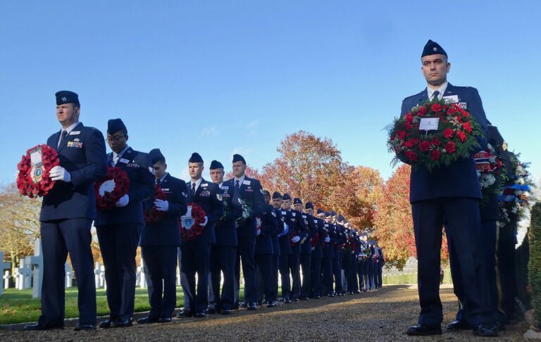 Airmen stand with wreaths during the 2018 Veterans Day Ceremony at Cambridge American Cemetery. Image courtesy of David Cross.