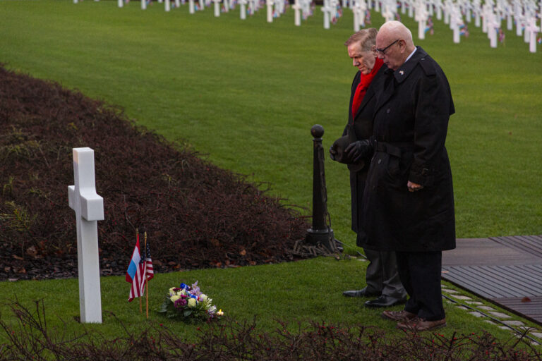 U.S. Ambassador to Luxembourg Randy Evans and Secretary of the American Battle Monuments Commission William Matz pay their respect at Gen. George S. Patton's grave at Luxembourg American Cemetery during the Battle of the Bulge 75th Anniversary luminary.