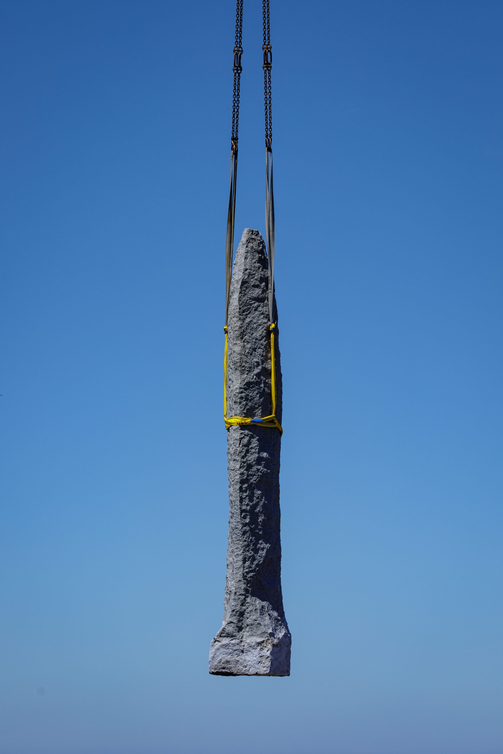The dagger of the Pointe du Hoc Ranger Monument being moved by a crane. Credit: American Battle Monuments Commission.