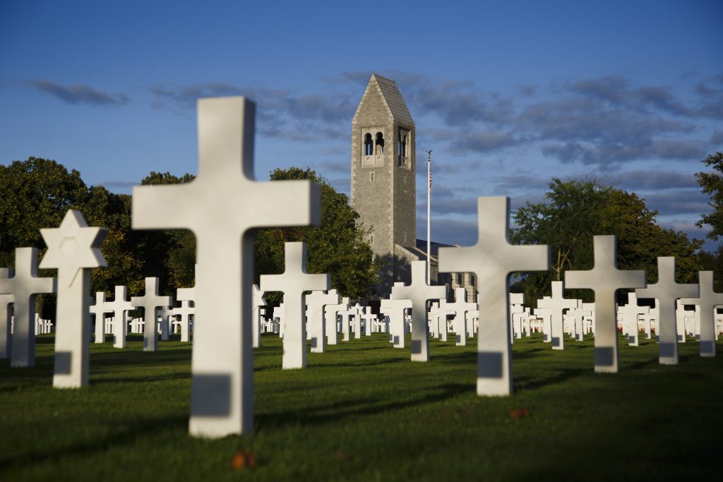 Picture of Brittany American Cemetery with some headstones and the chapel. Credit: American Battle Monuments Commission/ Warrick Page.