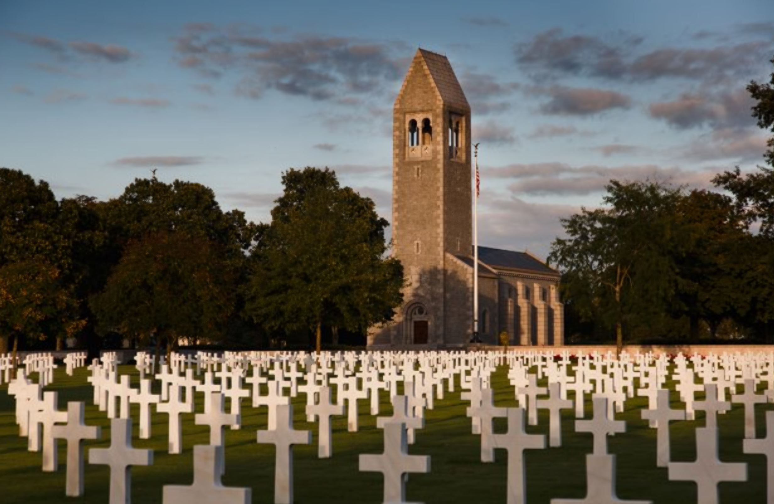 Picture of Brittany American Cemetery with the headstones in the front and the chapel in the background. Credit: American Battle Monuments Commission.