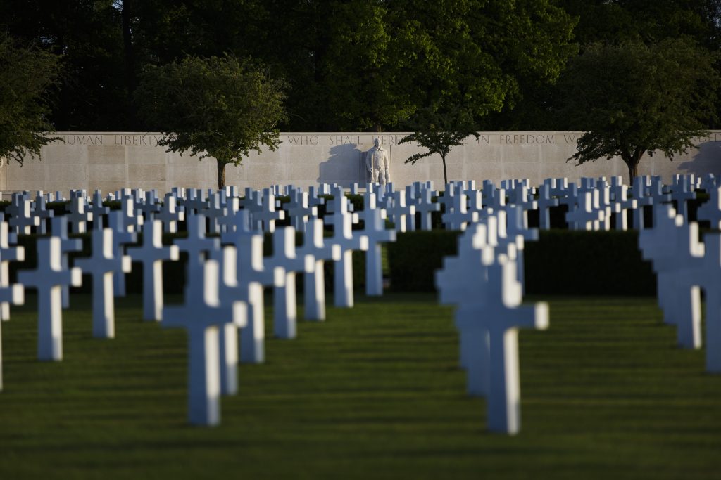 View of Cambridge American Cemetery with rows of white crosses and the wall of the missing as seen at the Cambridge American Military Cemetery, in Cambridge, England