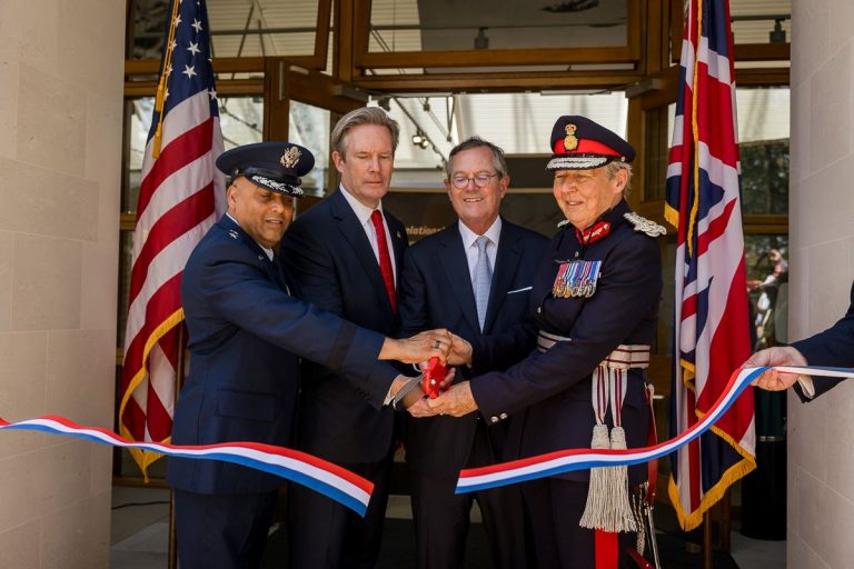 Maj. Gen. Akshai M. Gandhi, U.S. European Command; ABMC Commissioner John Freeman; Warren A. Stephens, U.S. Ambassador to the United Kingdom; and His Majesty's Lord Lieutenant of Cambridgeshire Julie Spence, cut the ribbon rededicating the visitor center at Cambridge American Cemetery May 25, 2026, after the launch of the redesigned exhibit. (ABMC/Richard Howell)