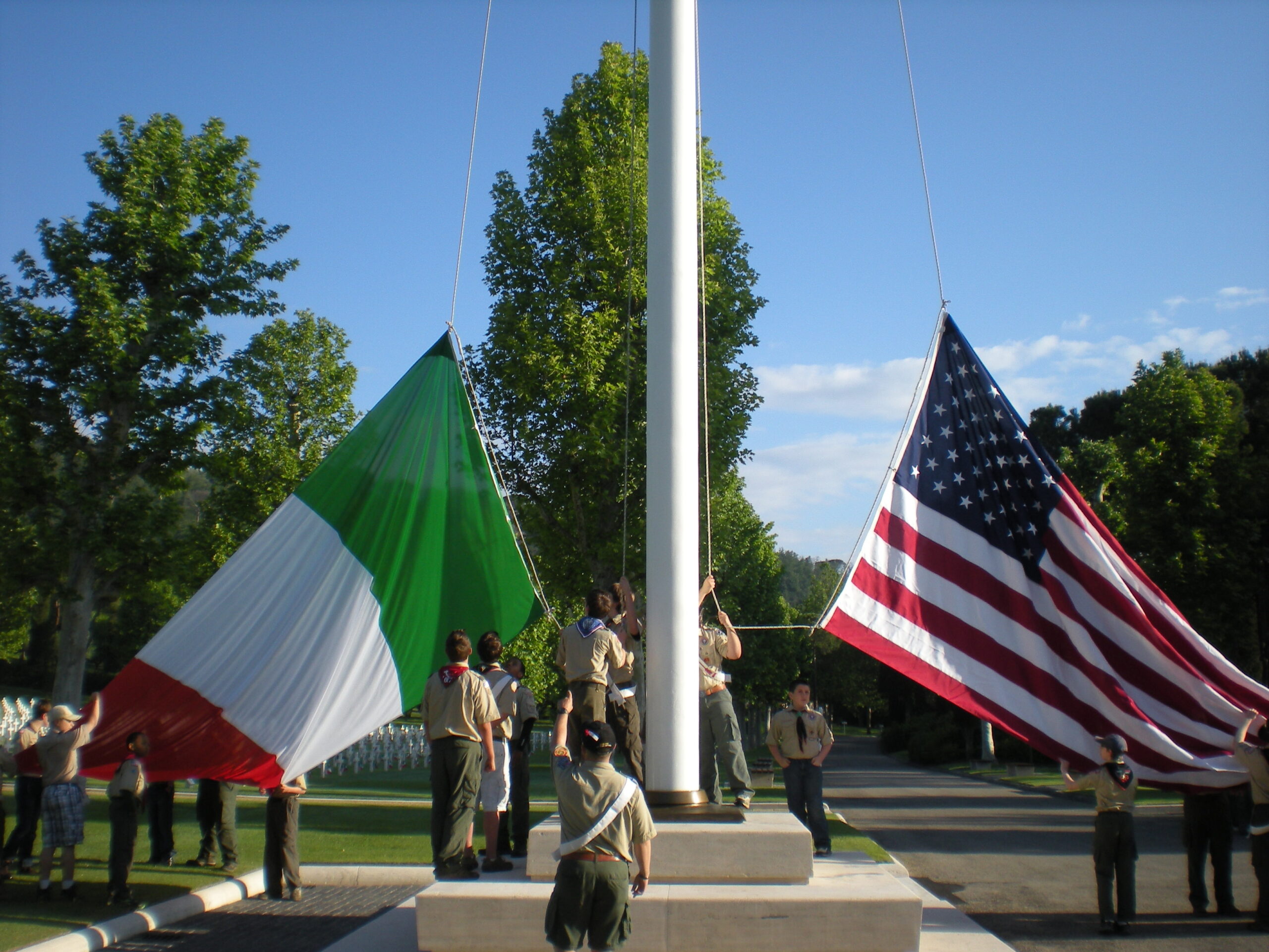 Boy Scouts raise the Italian and American flag at Florence American Cemetery in Italy during the 2013 Memorial Day ceremony.