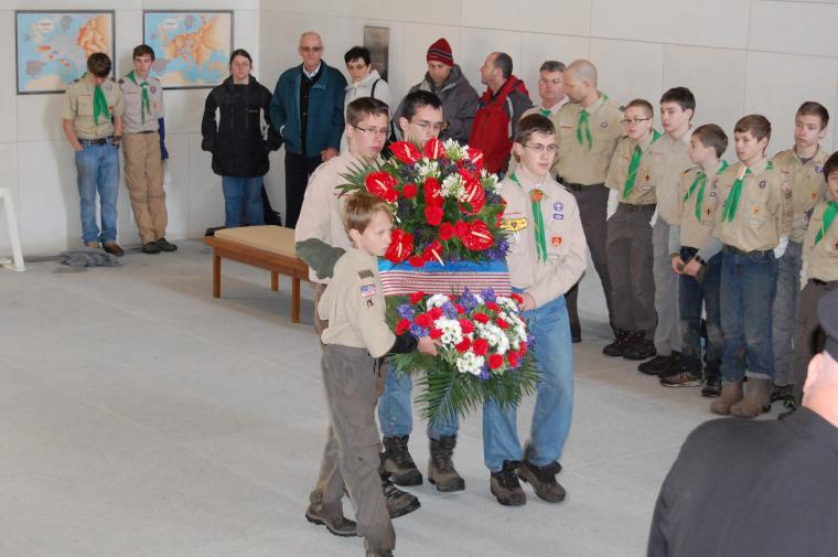 Boy Scouts carry a wreath as part of the Veterans Day 2013 Ceremony at Ardennes American Cemetery.