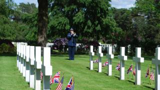 A bugler plays during the 2014 Memorial Day Ceremony at Brookwood American Cemetery in England.
