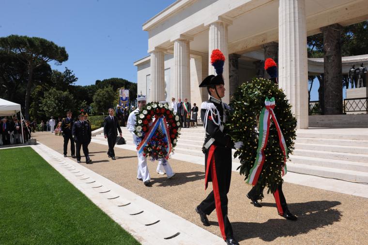 Members of the Italian military and the American military participate in a wreath-laying during the 2014 Memorial Day Ceremony at Sicily-Rome American Cemetery in Italy.