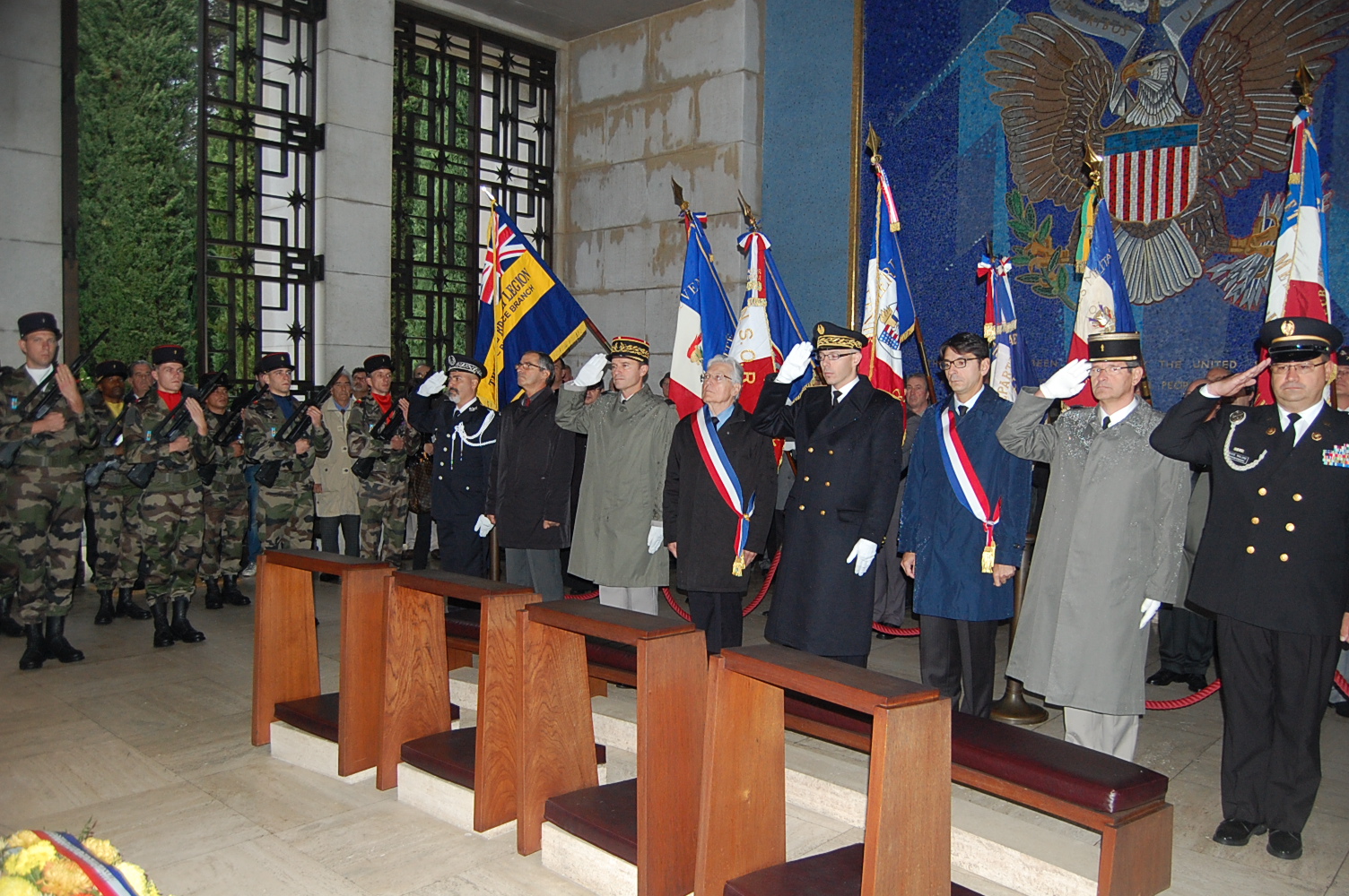 Participants salute in the chapel during the 2012 Veterans Day Ceremony at Rhone American Cemetery.