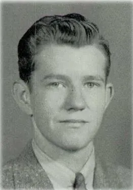 A black and white headshot of Pfc. John Chappell in a suit.