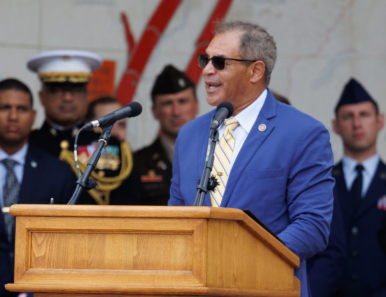 ABMC Chairman Michael X. Garrett delivering remarks at Normandy American Cemetery for June 6, 2025, ceremony. Credit: American Battle Monuments Commission/Anthony Gaudun.