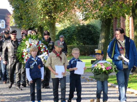 Boy scouts walk into the cemetery for the ceremony.