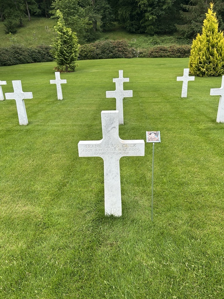 Picture of the headstone of 1st Sgt. Frank L. Glick with his picture near it for Faces of Aisne-Marne American Cemetery. Credit: American Battle Monuments Commission.  