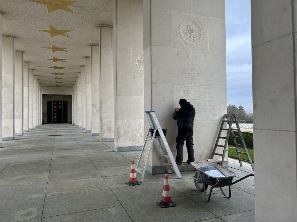 An engraver adds the name of Flight Officer Robert J. Marsh on the Walls of the Missing Feb. 20, 2025, at Henri-Chapelle American Cemetery in Hombourg, Belgium.