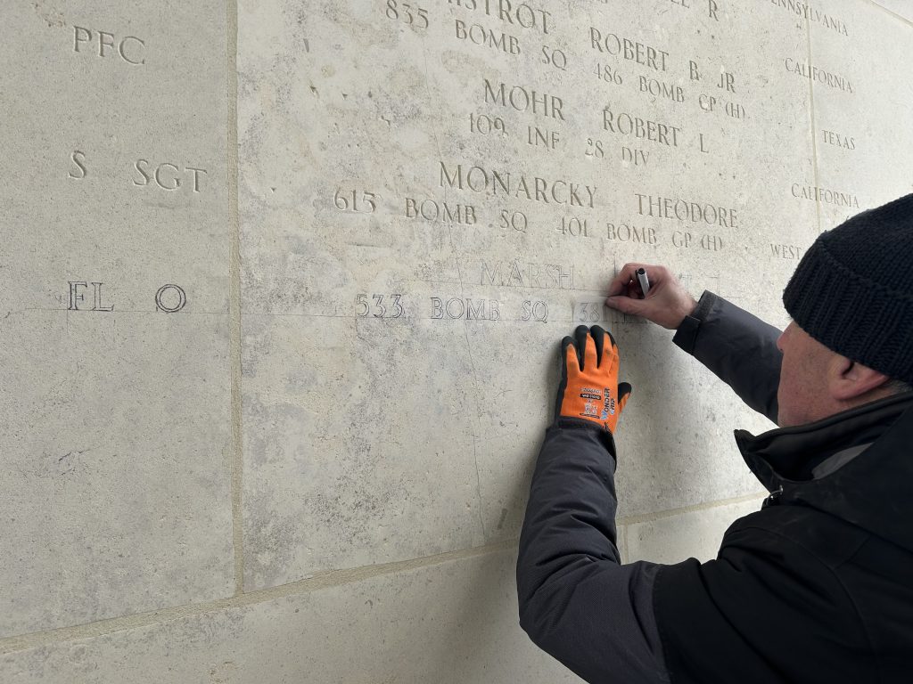 An engraver adds the name of Flight Officer Robert J. Marsh on the Walls of the Missing Feb. 20, 2025, at Henri-Chapelle American Cemetery in Hombourg, Belgium.