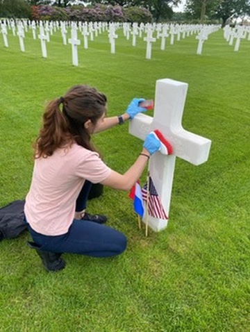 Anaiya Harris, a U.S. Air Force ROTC cadet from Brigham Young University in Provo, Utah, washes a headstone at Netherlands American Cemetery during the ABMC International Fellowship. Credits: American Battle Monuments Commission. Anaiya Harris, a U.S. Air Force ROTC cadet from Brigham Young University in Provo, Utah, washes a headstone at Netherlands American Cemetery during the ABMC International Fellowship. Credits: American Battle Monuments Commission.