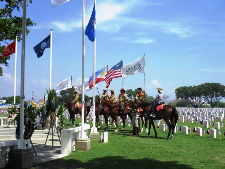 Men an horses participate in the 2016 Memorial Day Ceremony at Clark Veterans Cemetery.