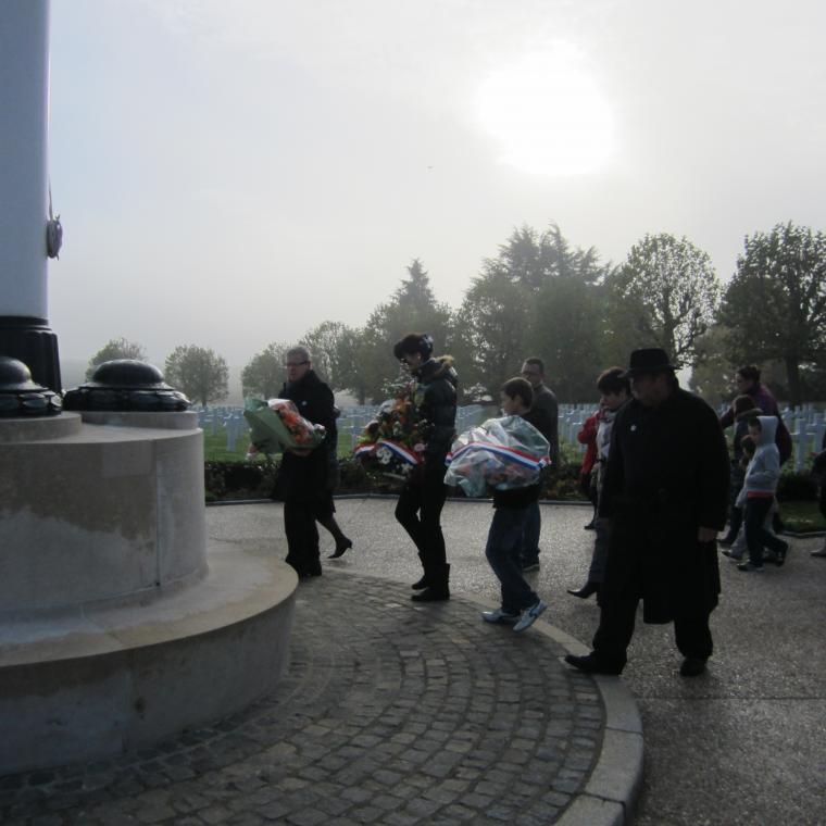 Participants prepare to lay floral wreaths during the 2013 Veterans Day Ceremony at Somme American Cemetery.