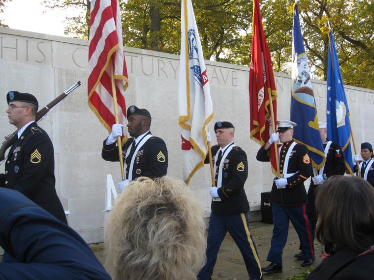 A U.S. Honor Guard marches during the 2014 Veterans Day Ceremony at Cambridge American Cemetery.