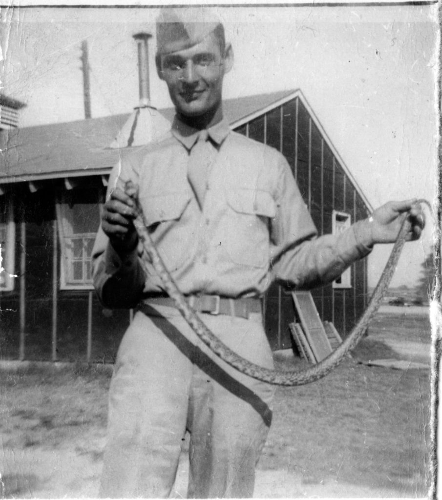Madore holding a snake at Camp Van Dorn in Centreville, Mississippi, 1944. Courtesy of Robert Madore.