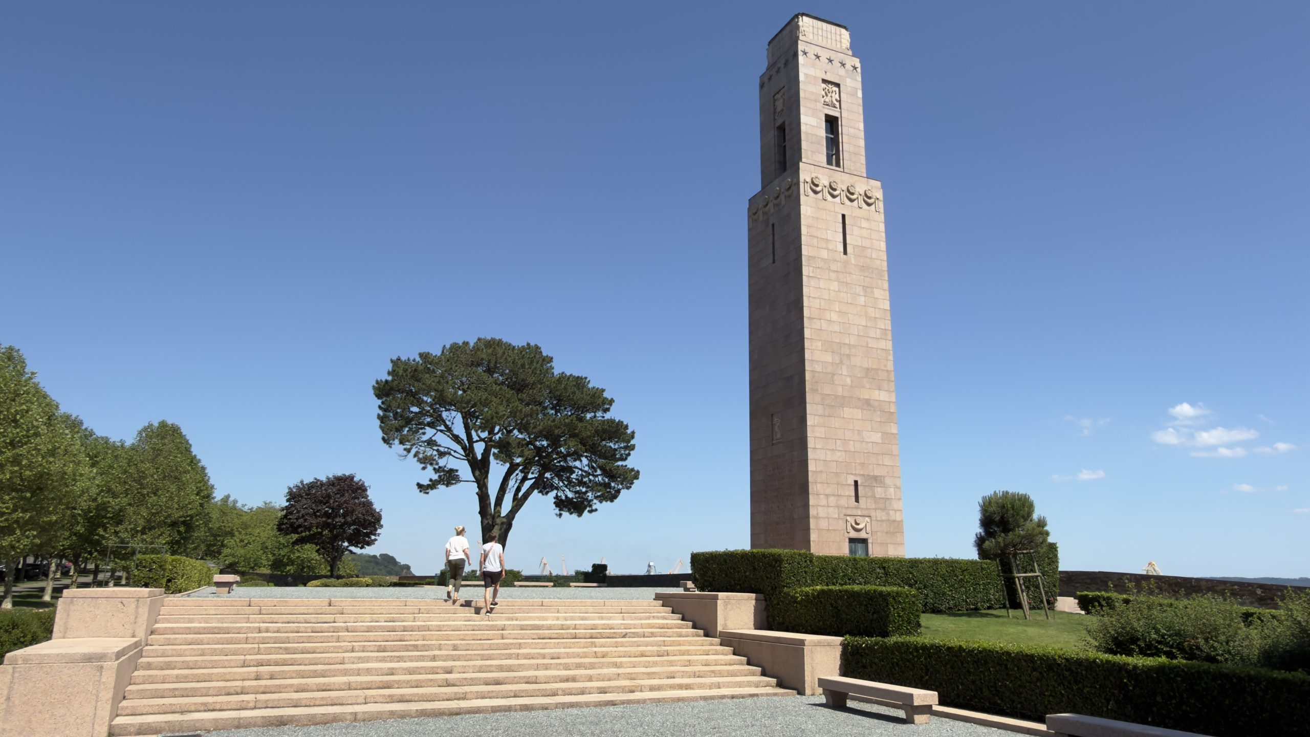 The Naval Monument at Brest on a sunny day with clear sky and people walking up the stairs.