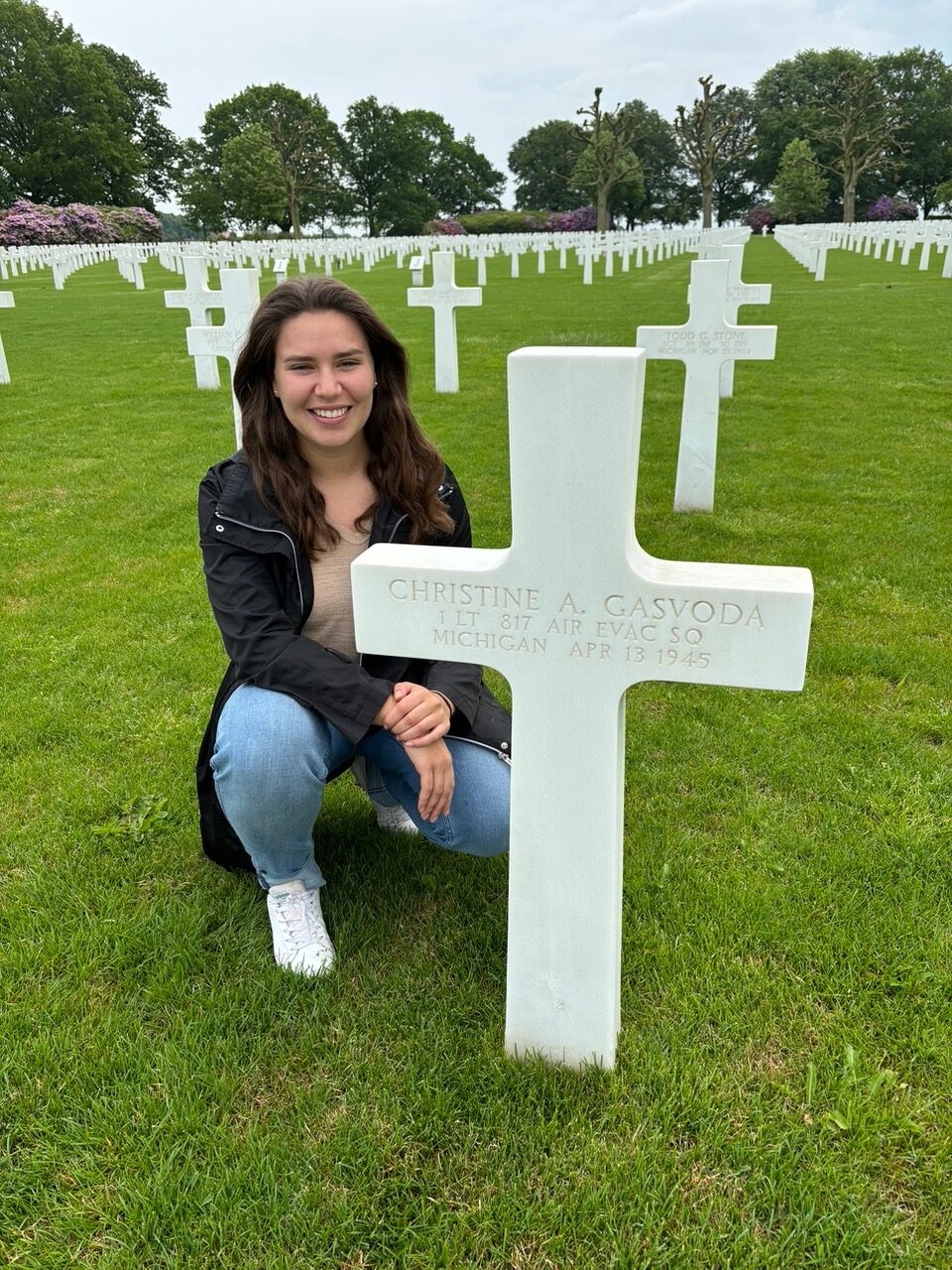 U.S. Air Force ROTC cadet and ABMC International Fellow Catherine Prince poses next to the headstone of 1st Lt. Christine A. Gasvoda. While learning more about the service members buried at the site, Prince learned one of the four women buried there was a native of a town near her home. Credits: American Battle Monuments Commission. U.S. Air Force ROTC cadet and ABMC International Fellow Catherine Prince poses next to the headstone of 1st Lt. Christine A. Gasvoda. While learning more about the service members buried at the site, Prince learned one of the four women buried there was a native of a town near her home. Credits: American Battle Monuments Commission.
