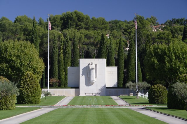 Picture of Rhone American Cemetery with the chapel and the flag poles. Credit: American Battle Monuments Commission/ Robert Uth.