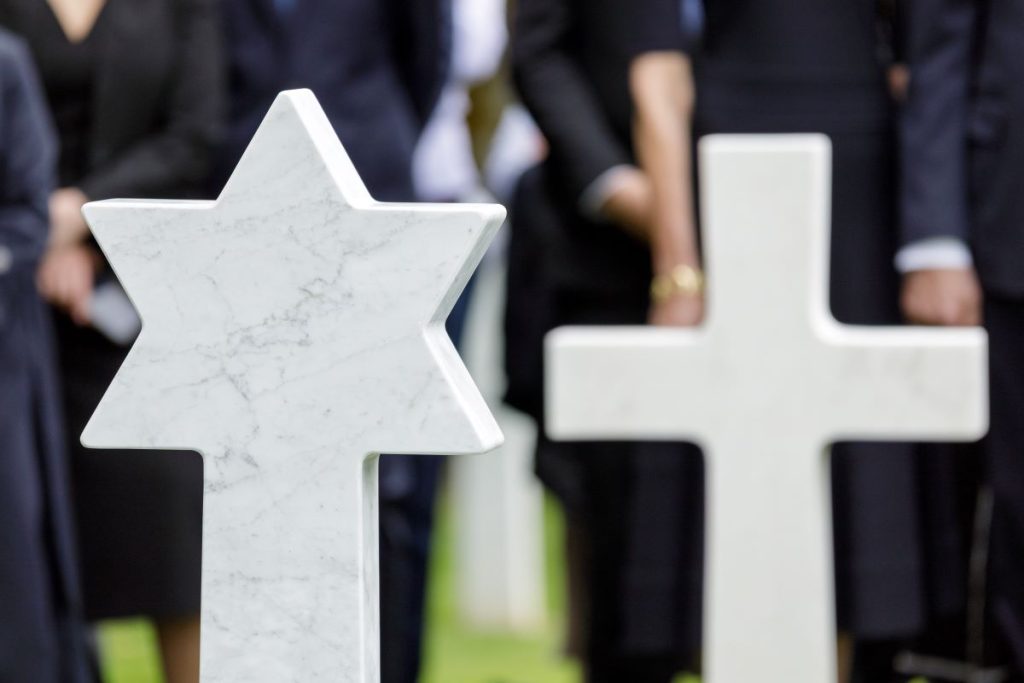 A Star of David and a Latin cross headstone at Meuse-Argonne American Cemetery. June 2, 2026, ABMC and Operation Benjamin changed five headstones at the cemetery to reflect the service members' faith. (ABMC/NGuyen-Kim)
