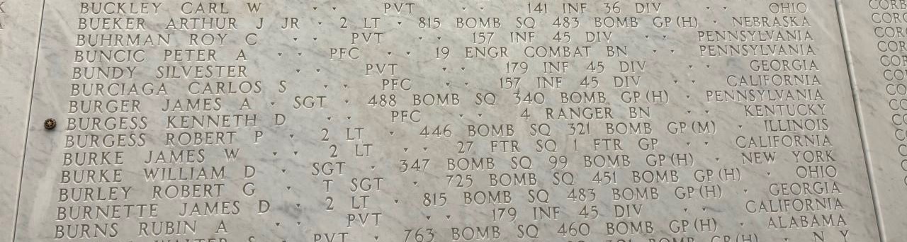 A bronze rosette is placed next to the name of Kenneth Burgess A bronze rosette is placed next to the name of Kenneth Burgess