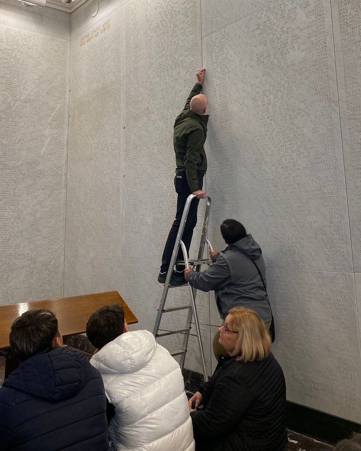 Staff at Sicily-Rome American Cemetery place a rosette Staff at Sicily-Rome American Cemetery place a rosette