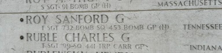 A bronze rosette is placed next to the name of U.S. Army Air Forces Tech Sgt. Sanford G. Roy on the Wall of the Missing at Netherlands American Cemetery.