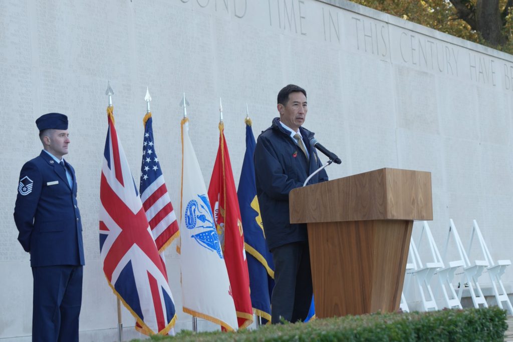 ABMC secretary Charles K. Djou delivering remarks at Cambridge American Cemetery for Veterans Day. Credits: American Battle Monuments Commission