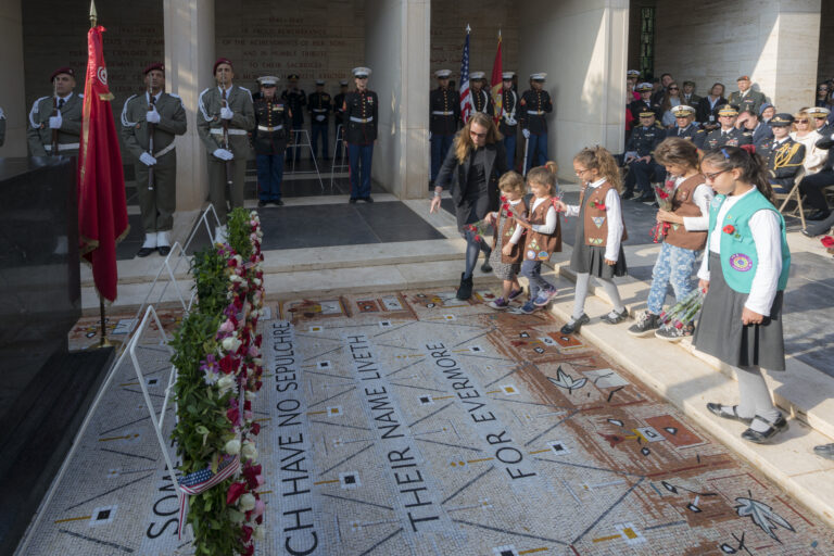 Girl Scouts of Brownie Troop 40502 and Junior Troop 40503 laid 22 roses during the 2018 Veterans Day Ceremony at North Africa American Cemetery in Tunisia. They did so in honor of the four women buried in the cemetery as well as the 18 honored on the Walls of the Missing.